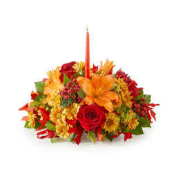 Autumn floral centerpiece with a red taper candle