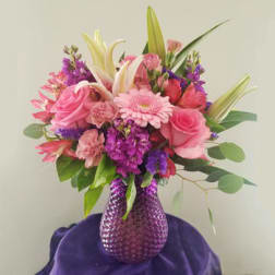 Pink and purple mixed bouquet in a textured purple vase