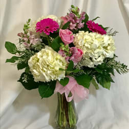 Pink and white mixed flower bouquet in a glass vase