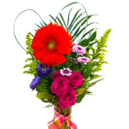 Colorful bouquet with a red gerbera daisy, pink roses, and purple flowers
