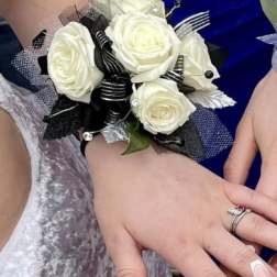 White rose wrist corsage with black ribbon and silver accents