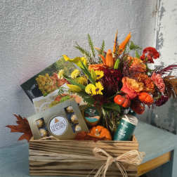 Mixed bouquet in a wooden gift box with chocolates and self-care items