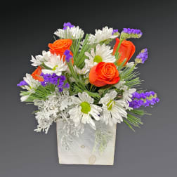 Orange roses and white daisies in a white wooden box