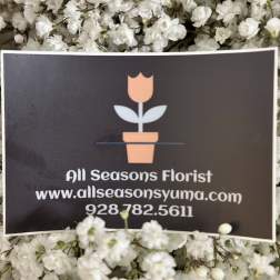 White baby's breath surrounds a florist business card