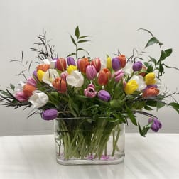 Colorful tulip bouquet in a clear glass vase