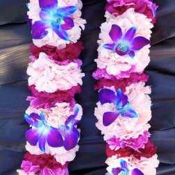Flower lei with pink and magenta blooms and blue-purple orchid accents