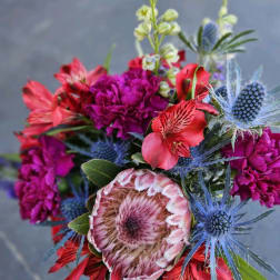 Bright mixed bouquet with magenta, red, and blue flowers