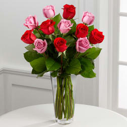Bouquet of red and pink roses in a clear glass vase