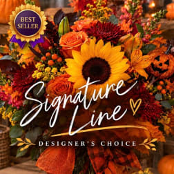 Autumn floral arrangement with sunflowers, roses, and a pumpkin accent