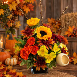 Fall bouquet with sunflowers, roses, and chrysanthemums in a black vase