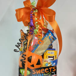 Halloween candy gift bag with an orange bow and pumpkin bucket