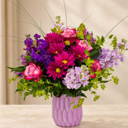 Pink and purple mixed bouquet in a lavender vase