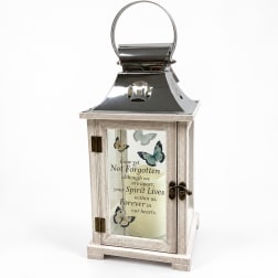 Decorative memorial lantern with butterfly design and a candle inside