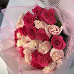 Bouquet of hot pink and blush roses wrapped in pink paper
