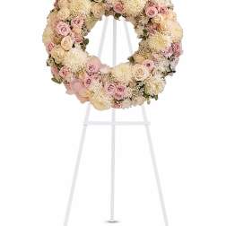 Pastel floral wreath on a white easel