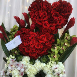 Large red rose arrangement with white and green orchids and white hydrangeas