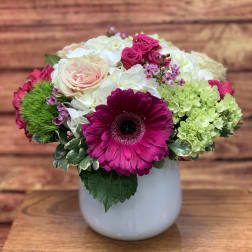 Mixed bouquet in a white vase with pink and white blooms