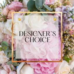 Pastel designer’s choice arrangement with pink hydrangeas and white and blush roses behind a text overlay.