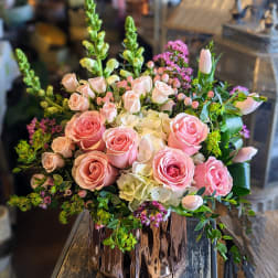 Pink roses and white hydrangeas in a copper vase