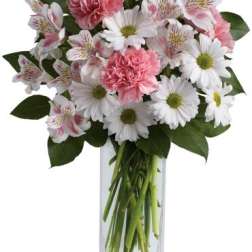 Tall bouquet of white daisies, pink carnations, and white alstroemeria in a clear rectangular glass vase