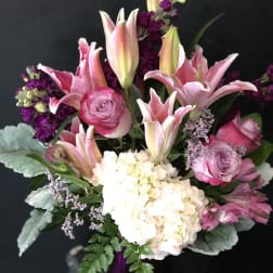 Pink lilies, roses, and white hydrangea in a bouquet