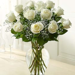 White roses arranged in a clear glass vase