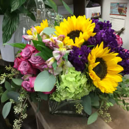 Bouquet with sunflowers, pink roses, purple blooms, and green hydrangea