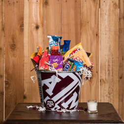 Texas A&M gift bucket filled with assorted snacks and a candle