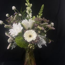 White and pale lavender mixed bouquet in a glass vase