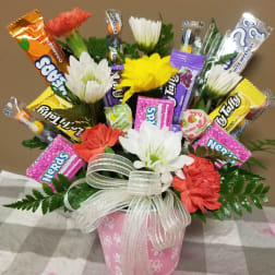 Candy bouquet with faux flowers in a pink pot and ribbon