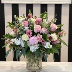 Pink and white floral arrangement in a clear glass vase