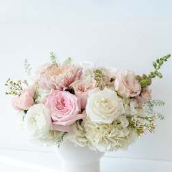 Pink and white flower arrangement in a white vase