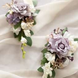Two lavender and white floral corsages on sheer fabric