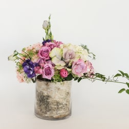 Mixed pink and purple bouquet in a glass vase