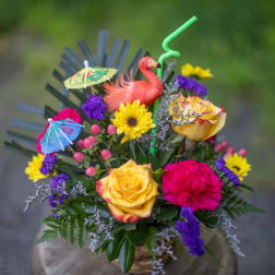 Tropical bouquet with roses, sunflower, carnation, and flamingo decoration