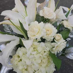 White floral bouquet with lilies, roses, and hydrangea