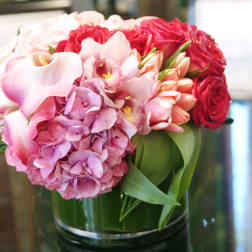 Pink and red floral arrangement in a glass vase