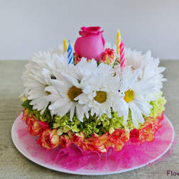 Flower cake with white daisies, pink rose, and striped candles