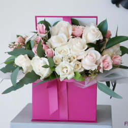 Pink and white rose bouquet in a bright pink gift box
