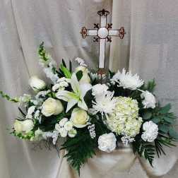 White floral spray with a decorative cross centerpiece