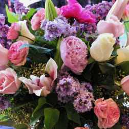 Bouquet of pink roses, peonies, lilies, and purple flowers