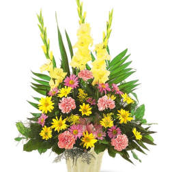Tall arrangement of yellow gladiolus, pink carnations, and yellow daisies in a cream textured container