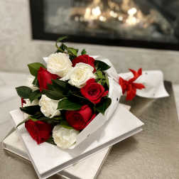 Bouquet of red and white roses wrapped in white paper