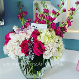 Bouquet of pink roses and white hydrangeas in a glass vase