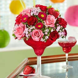 Bouquet of red and pink roses in a red stemmed glass