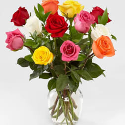 Bouquet of multicolored roses in a clear glass vase