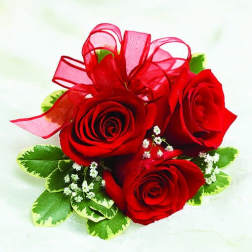 Three red roses with a red ribbon bow and small white filler flowers