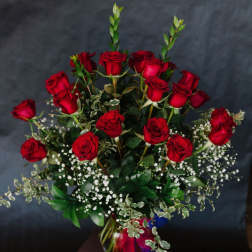 Bouquet of red roses with baby's breath in a vase