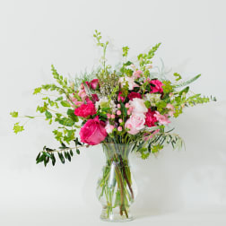 Pink and white mixed flower arrangement in a clear glass vase