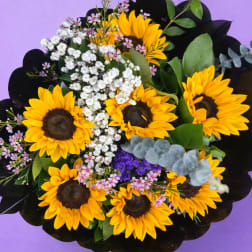 Bouquet of yellow sunflowers with white and pink filler flowers